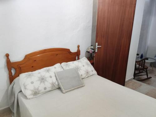 um quarto com uma cama com um computador portátil em La Casilla: Casa acogedora a los pies de la Atalaya. em Níjar
