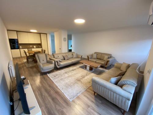 a living room with couches and a table at Prizren City 2 bedroom apartment in Prizren