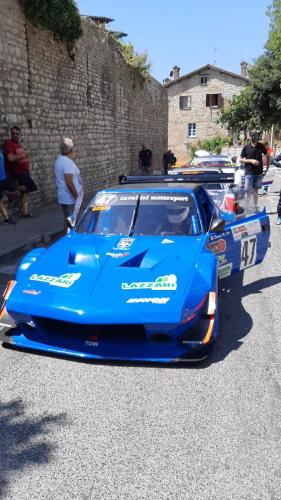 a group of cars parked next to a wall at Casa Gianfranco in Gubbio