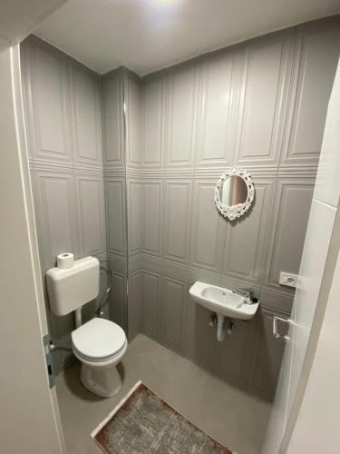 a bathroom with a toilet and a sink at Prizren City 2 bedroom apartment in Prizren