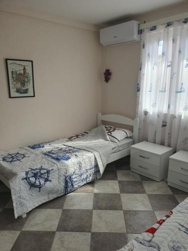 a bedroom with two beds and a tiled floor at Villa Blanca in Bar