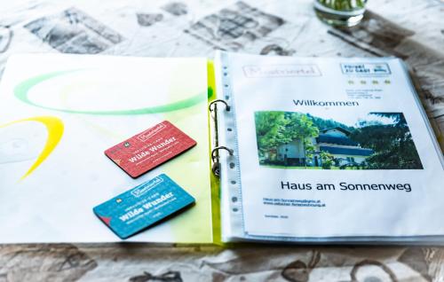 an open book on a table with passports at Haus-am-Sonnenweg in Lackenhof