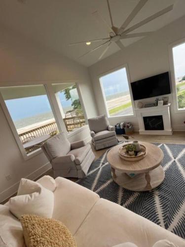 a living room with a couch and a table at Beauty on the Beach Gulf Luxury w/ Gorgeous Views in Gulfport