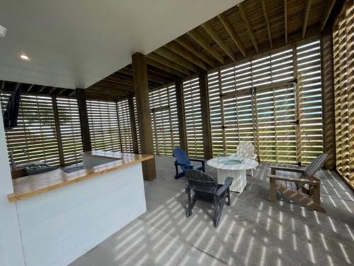 a room with a table and chairs and windows at Beauty on the Beach Gulf Luxury w/ Gorgeous Views in Gulfport