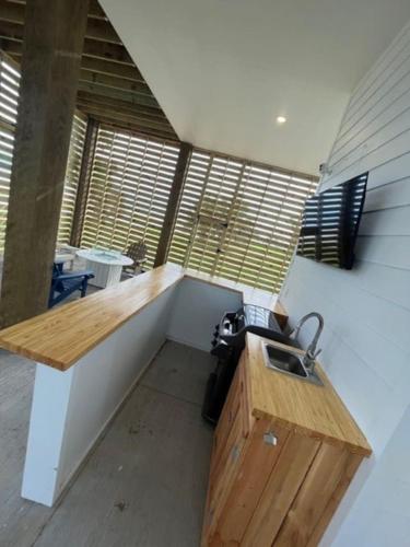 a kitchen with a sink in a room with windows at Beauty on the Beach Gulf Luxury w/ Gorgeous Views in Gulfport