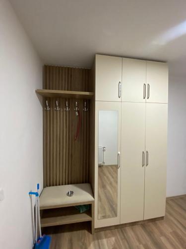 a room with white cabinets and a closet at Prizren City 2 bedroom apartment in Prizren