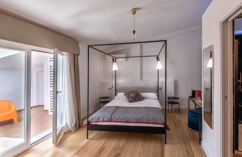 a bedroom with a canopy bed with two lamps at Bisu Isola di Sant'Antioco in SantʼAntìoco