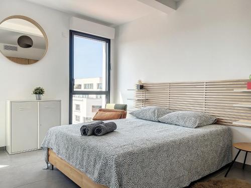 une chambre avec un grand lit avec un miroir au mur dans l'établissement Sunrise du Panier - Climatisation & Central - Les Frères de la Loc', à Marseille