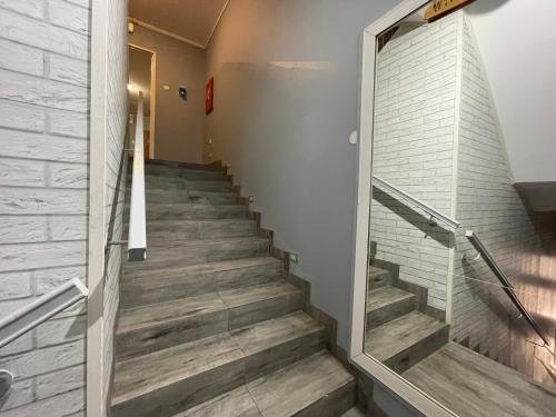 a staircase in a building with wooden floors at CBC Pokoje Hotelowe in Starogard Gdański