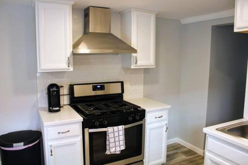 a kitchen with a stove and a microwave at The Clark - Suite 1W - Ocean Grove near Asbury in Ocean Grove
