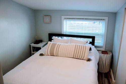 a bedroom with a white bed with a window at The Clark - Suite 1W - Ocean Grove near Asbury in Ocean Grove