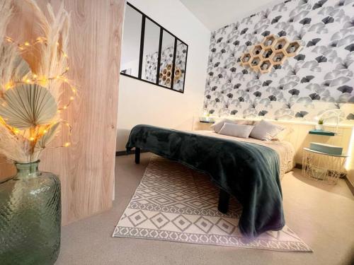 干邑的住宿－Studio Charmant hyper centre Cognac，一间设有一张桌子和花瓶的床的房间