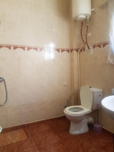 a bathroom with a toilet and a sink at hay massira 4 in Dakhla