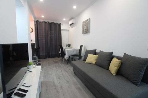 a living room with a couch and a table at Varanda do Bonfim in Setúbal