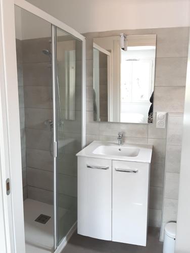 une salle de bain avec un lavabo blanc et une douche dans l'établissement Appartement T2 en Corse dans résidence avec piscines proche de Porto Vecchio, à Lecci