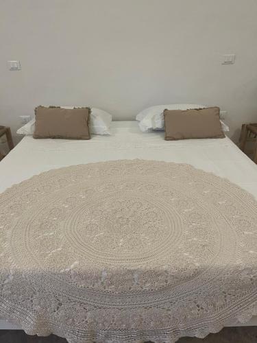 a white bed with two pillows on top of it at L’Edicola Votiva in Casarano