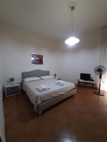 a bedroom with a large bed and a fan at Casa Ricordi in Vietri sul Mare