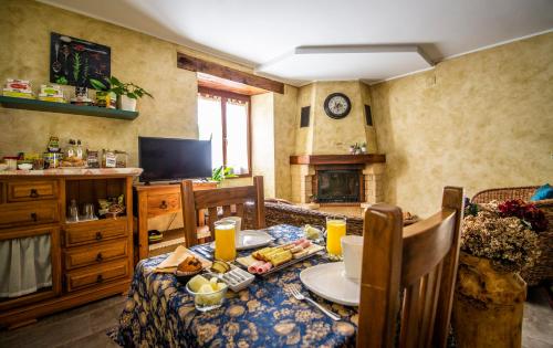 a dining room with a table with food on it at Casa Rural Korteta in Tolosa