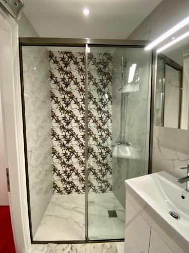 a bathroom with a shower and a sink at Corfu Port Art Studios in Agios Rokkos