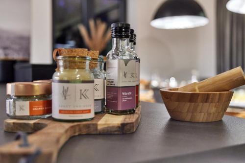 two bottles of essential oils sitting on a cutting board at Private Spa & Garden Alpi in Garmisch-Partenkirchen