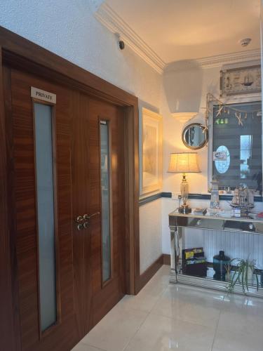 a kitchen with a sink and a wooden door at The Light House in Galway