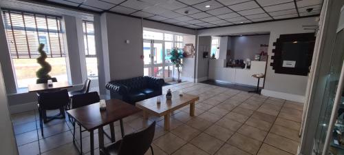 a living room with a table and chairs in a room at Arncliffe Lodge Hotel in Blackpool