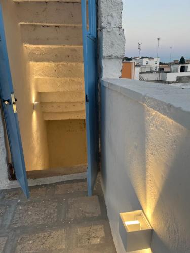 an open door to a stairwell with a stair case at L’Edicola Votiva in Casarano
