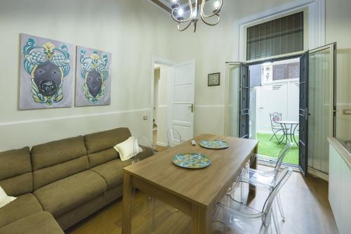 a living room with a couch and a table at Appartamento Martoglio - Casa Vacanze - in Catania