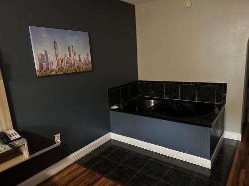 a bathroom with a black tub and a picture on the wall at Jameson Inn Conyers in Conyers