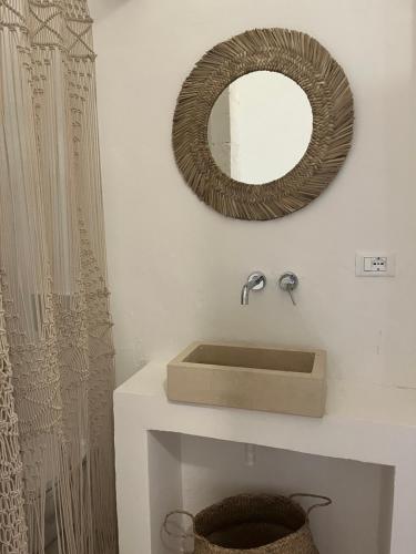 a bathroom with a sink and a mirror on the wall at L’Edicola Votiva in Casarano