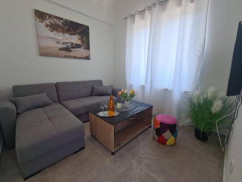 a living room with a couch and a coffee table at Lady Di apartments in Kaštela