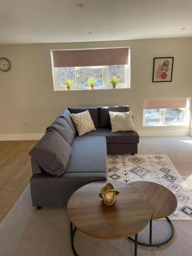 a living room with a couch and a table at 18 All Saints Passage in Huntingdon