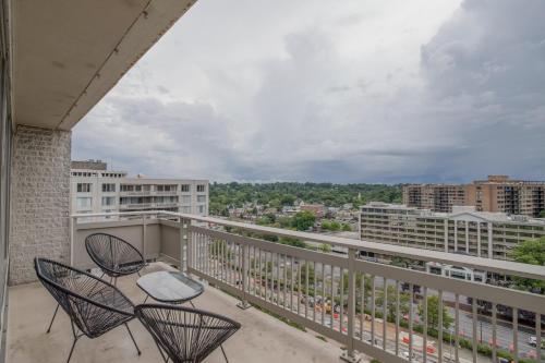 a balcony with chairs and a view of a city at Fantastic 2 BR Apt + Den @Crystal City With Gym in Arlington