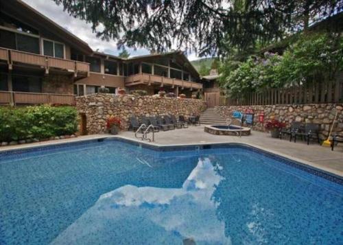 a large swimming pool in front of a house at Standard Two Bedroom - Aspen Alps #207 in Aspen