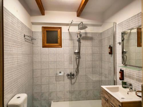 a bathroom with a shower and a sink at Elegant Vista Residence in Metsovo