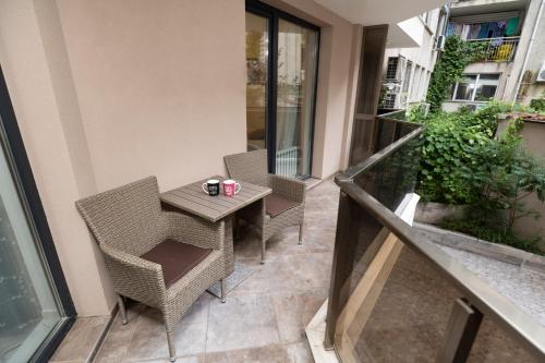 a balcony with a table and chairs on a building at Top Central Luxury Apartment & Free Parking in Sofia