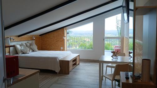 a bedroom with a bed and a large window at Casa Gabriel in Picassent