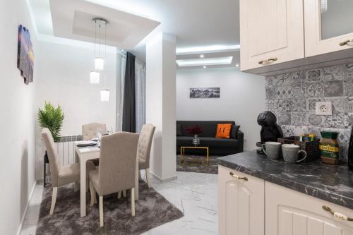 a kitchen and dining room with a table and chairs at Top Central Luxury Apartment & Free Parking in Sofia
