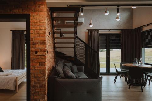 a room with a loft bed and a dining room at Enklawa in Nowy Podleś
