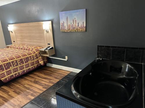 a bathroom with a black sink and a bed at Jameson Inn Conyers in Conyers