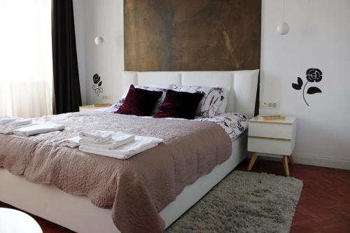 a bedroom with a bed with towels on it at Apartment Amber Rijeka in Rijeka