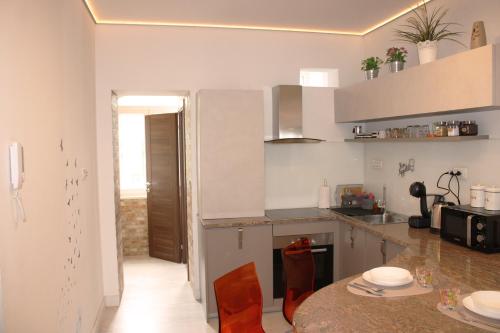 a kitchen with a counter and a table with chairs at Apartment Amber Rijeka in Rijeka