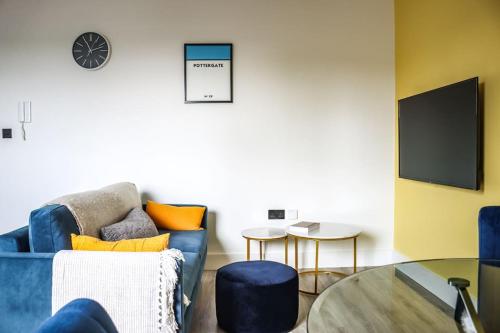 a living room with a blue couch and a table at Funky Flat - City Centre - Free Parking in Norwich