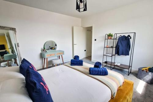 a bedroom with a large bed with blue pillows on it at Funky Flat - City Centre - Free Parking in Norwich