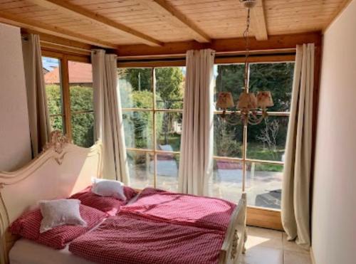 a bedroom with a bed in front of a window at Ferienwohnung SISSI in Rieden