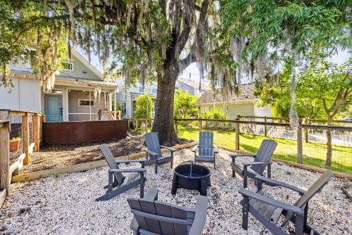 a patio with chairs and a fire pit under a tree at The Polygon Park Circle Mins to Dwtn and Beach in Charleston
