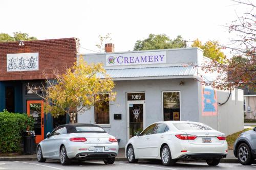 two white cars parked in front of a pharmacy at The Polygon Park Circle Mins to Dwtn and Beach in Charleston