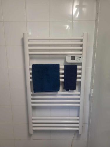 a towel rack in a bathroom with two blue towels at Petite maison Juvisy, Orly 7 min, Paris 15min in Juvisy-sur-Orge