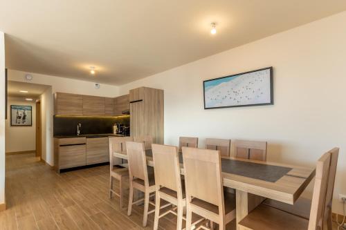 a kitchen and dining room with a table and chairs at Ridge302 in Bourg-Saint-Maurice