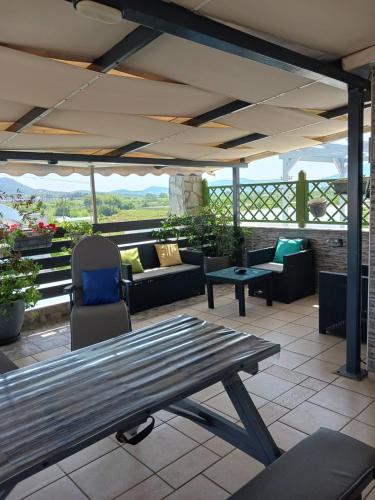 a patio with couches and a table and chairs at Green House in Néa Péramos